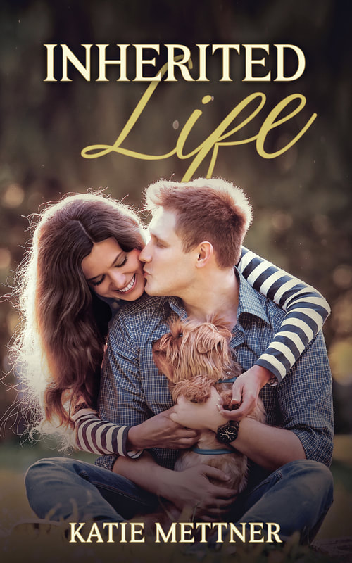An interracial couple is sitting in a summer park. The man is sitting on the ground holding a small dog. The woman is behind him with her arms around his shoulders and he is kissing her cheek. It says, "Inherited Life, Katie Mettner"