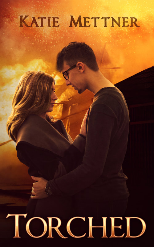 "The background is a house that is burning with flames. There is a fireman's ladder and water spraying onto the fire. In the front of the image is a couple. he is wearing a brown sweater, black glasses, and has brown hair. She is wearing a brown dress, and has long brown hair. It says, Torched, Katie Mettner"